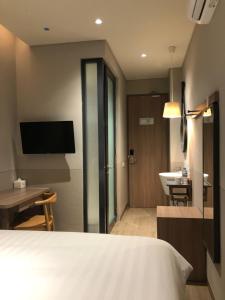 Ένα ή περισσότερα κρεβάτια σε δωμάτιο στο Citrip Hotel Simpang Lima