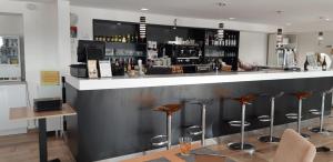 a bar with stools in front of a counter at Studio à Deux Pas d'Aix in Aix-en-Provence