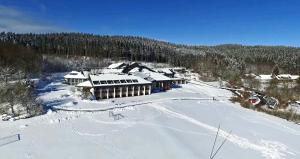 an aerial view of a building in the snow at Landhaus Nordhelle Garni in Meinerzhagen
