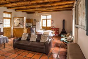 a living room with a couch and a kitchen at Plaas Wegbreek in Barrydale