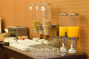 a counter with glasses of orange juice and drinks at Hotel Sapana Garden Thamel in Kathmandu