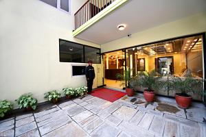 a man standing in the doorway of a house at Hotel Sapana Garden Thamel in Kathmandu