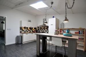 a kitchen with a large wooden table and chairs at De Smidse in Lobith