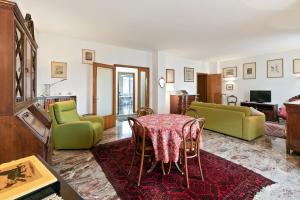 a living room with a table and chairs at Condominio Torcello Vintage Apartment in Mestre