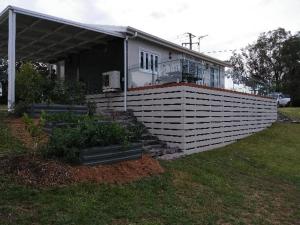 a house with a fence in front of it at All seasons holiday homes in Tumut