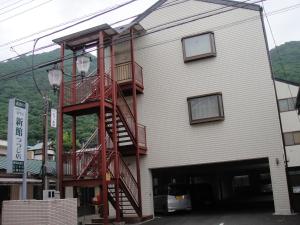 a building with a fire escape on the side of it at Sudomari Hotel Roman Tsutsuji in Nikko