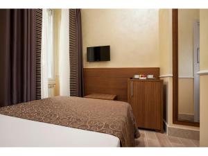 Postel nebo postele na pokoji v ubytování Hotel Kennedy