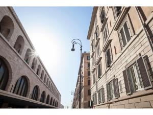 a street with two tall buildings and a street light at Hotel Kennedy in Rome
