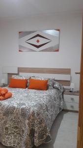 een slaapkamer met een bed met oranje kussens bij PATIO POMPEYOS in Córdoba