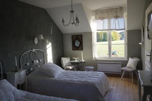 מיטה או מיטות בחדר ב-Le Manoir des Arômes