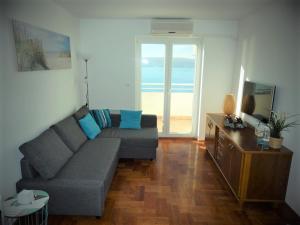 a living room with a couch and a television at Aspectus Apartment in Crikvenica