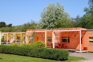 a row of modular homes in a park at Piejūras Kempings in Ventspils