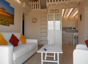 a living room with a white couch and a table at Cottage with pool,views in Citta' Sant'Angelo