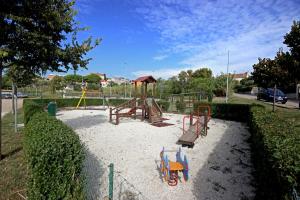 a playground with a swing set in a park at Apartments Lara Pula in Pula