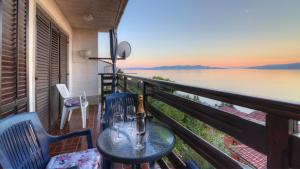 a balcony with a table and chairs and a view of the water at Apartment Lea in Senj