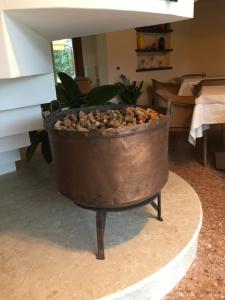 a large pot sitting on a stand in a living room at Crystal Luxury House in Fiume Veneto