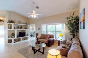 a living room with a couch and a table at Marco Sands in Marco Island