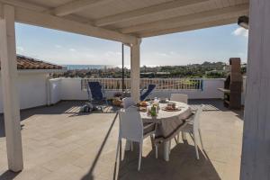 a table and chairs on a patio with a view at Mareinsicilia Cannamara Appartamenti in Donnalucata
