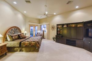 a large bedroom with a bed and a tv at Camino Antonio in Tucson