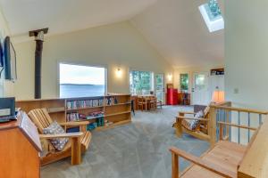 a living room with wooden furniture and a large window at The Cabin at Oak Bay in Port Ludlow