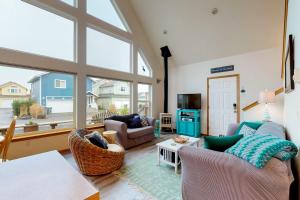 a living room with furniture and a large window at Blue Wave Cottage in Pacific Beach