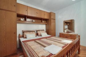 a bedroom with a large bed with wooden cabinets at Apartment Lea in Senj
