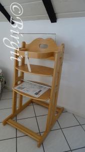 a wooden chair sitting on a tiled floor at Gästehaus Streich Refrath, Bergisch Gladbach in Bergisch Gladbach