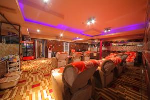 a large room with couches and chairs in it at New World Hotel in Ulaanbaatar
