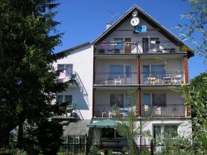 a tall white building with balconies on it at DW FALA in Rewal