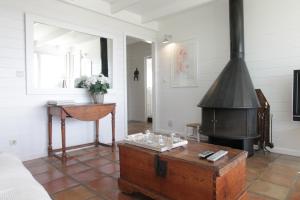 a living room with a stove and a table at El Caprichio in Gaucín