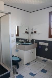 a bathroom with a sink and a toilet at LE LOGIS DE L'ETORE in Saint-Jean-dʼAngély