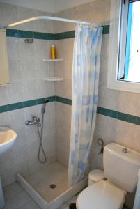 a bathroom with a shower and a toilet and a sink at BAY VIEW STUDIO in Megas Gialos - Nites +14 photos