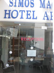 a reflection of a woman in a window of a store at Simos Magic Hotel Apts in Ayia Napa