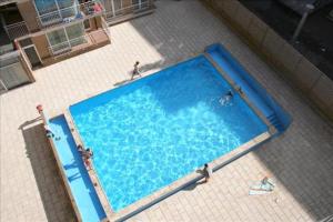 an overhead view of a large blue swimming pool at Résidence Atlantic in Koksijde