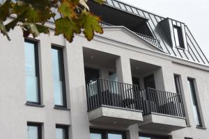 an external view of a building with balconies at meerZEIT Norderney in Norderney