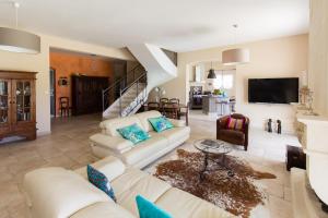 a living room with a couch and a tv at A True Paradise for unforgettable vacation – Villa Pool and Sea View in Nice