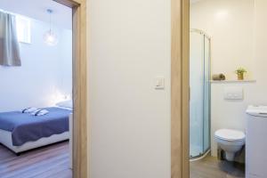a bathroom with a bed and a toilet in a room at Villa Niki 2 in Cavtat +117 photos