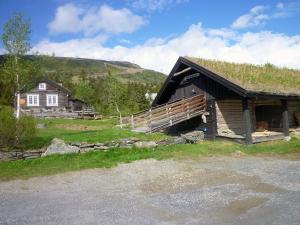 a log cabin with a grass covered roof at Skei Apartments in Svingvoll