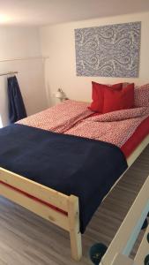 a bedroom with a bed with red pillows at Pause Apartment with Free Parking in Budapest