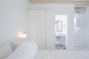 A bed or beds in a room at Aether Boutique Stay