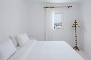 A bed or beds in a room at Aether Boutique Stay