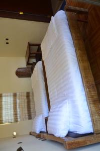 a stack of pillows on a bed in a room at Selam Guest House in Lalibela +9 photos