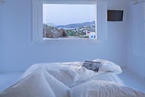 A bed or beds in a room at Aether Boutique Stay