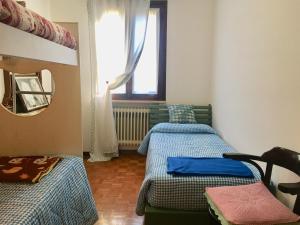Säng eller sängar i ett rum på Appartamento Casa della Nonna
