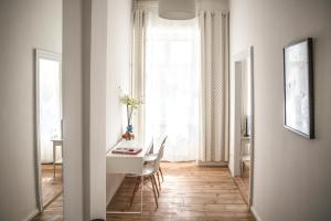 Pension Absolut Berlin في برلين: غرفة بيضاء مع طاولة وكراسي ونافذة