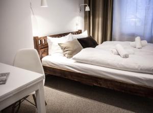 a bedroom with a bed with white sheets and pillows at Pension Absolut Berlin in Berlin