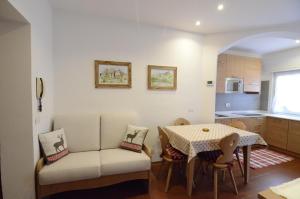 a kitchen and dining room with a table and chairs at Continental 102 - 4 beds in San Vito di Cadore