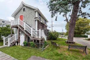 a house with a tree and a bench at HI Hyannis Hostel in Hyannis