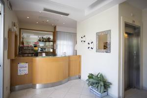 a restaurant with a counter in a room at Hotel Savana in Rimini