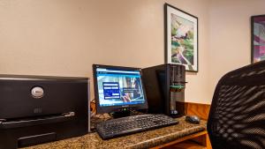 a desk with a computer and a monitor and keyboard at Hotel Edgewater in Seward